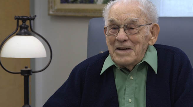 Photo of an elderly man sitting in a chair