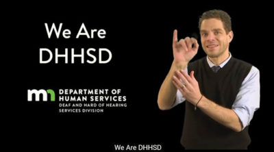 A man is signing in ASL in front of a background that says We Are DHHSD, along with a logo of the MN Department of Human Services