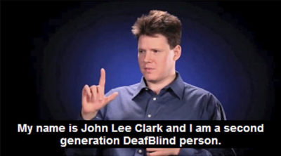 A young man is signing and the captioning says: My name is John Lee Clark and I am a second generation DeafBlind person.