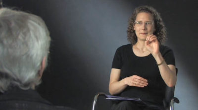 Photo of a deaf woman signing with another deaf woman in an interview setting